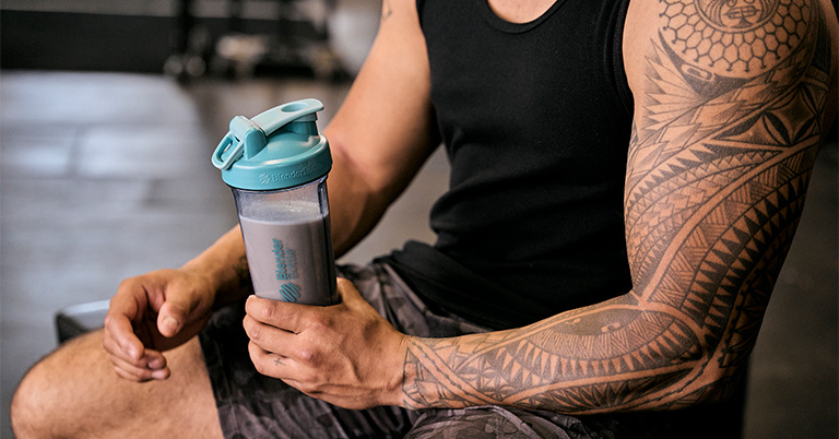 Man holding a protein shaker in a BlenderBottle brand protein shaker bottle